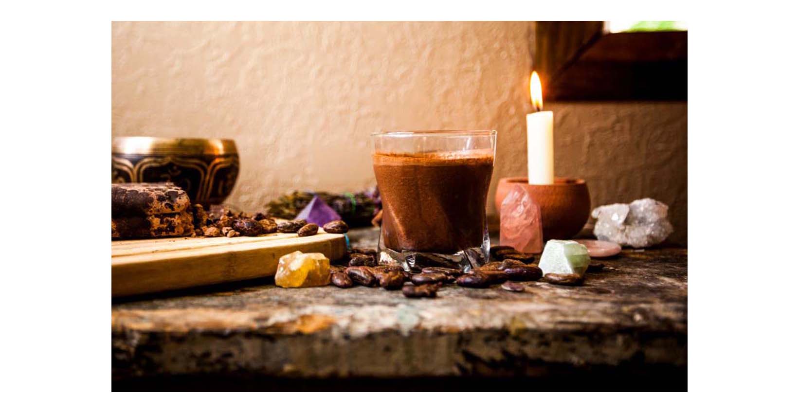 raw cacao cup with a candle and crystals