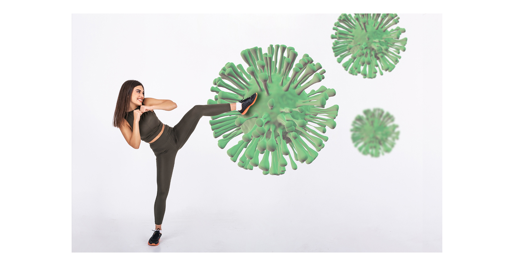 A woman kicking a large representation of a virus
